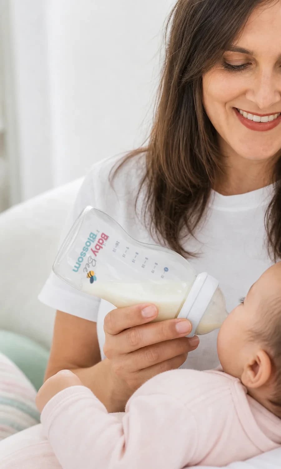 Close-up parent testing photo of a feeding bottle held during a calm feed