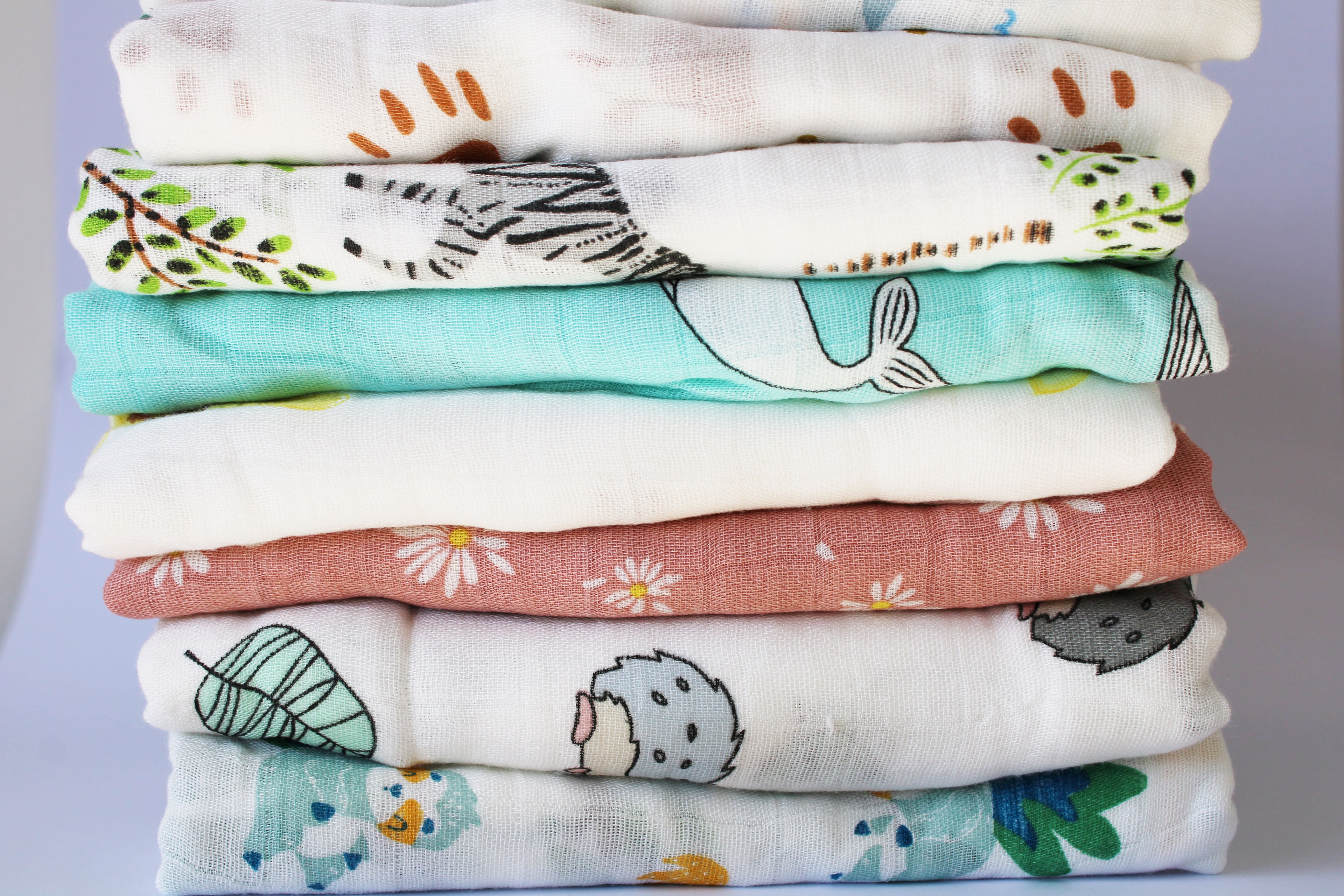 Baby Bee Blossom muslin swaddle collection stacked together
